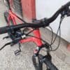 Close-up of mountain bike handlebar with gear shifter and brake lever.