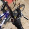 Close-up of mountain bike handlebar with Shimano gear shifter and brake lever.