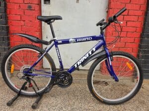 Blue Trinity mountain bike with 26-inch wheels and front suspension.
